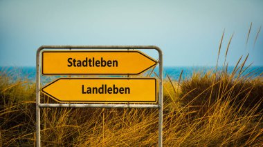 An image with a signpost pointing in two different directions in German. One direction points to city life, the other points to country life. clipart