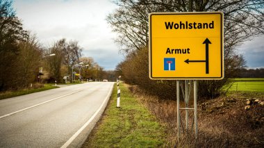 Almanca 'nın iki farklı yönünü gösteren işaret direği olan bir resim. Bir yön zenginliği gösterir, diğeri yoksulluğu..