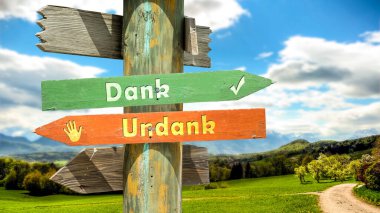 Almanca 'nın iki farklı yönünü gösteren işaret direği olan bir resim. Bir yön teşekkür eder, diğer yön nankörlük eder..