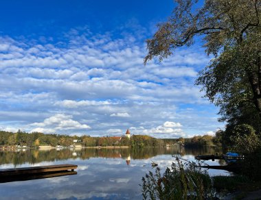 Güzel bir akşam manzarası. Bulutlar. Sudaki ağaçların ve bulutların yansıması..