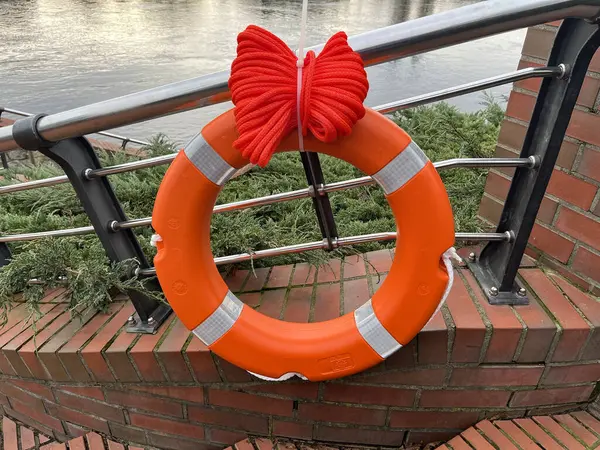 Lifebuoy on the embankment in a European city. Safety.