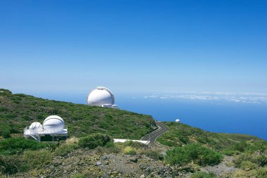 Panoramic views of the Roque de los Muchachos space observatory on a sunny day with a blue backgroun and some cloud. Horizontal view. Copy space.