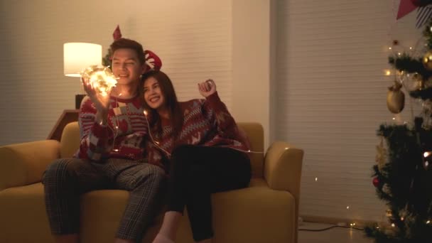 Asian Couple Wearing Sweaters Playing Tangled Led Lights Ball Together — Stock Video