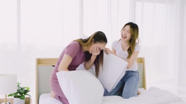 Two Happy Attractive Asian Women Having Pillow Fight Smiles Laugh — Stock videók