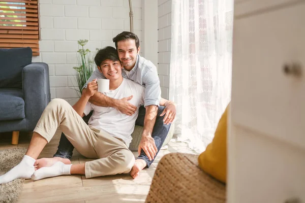 Caucasian Asian Lgbt Couple Embracing Back Sitting Drinking Cup Coffee — Stock Photo, Image