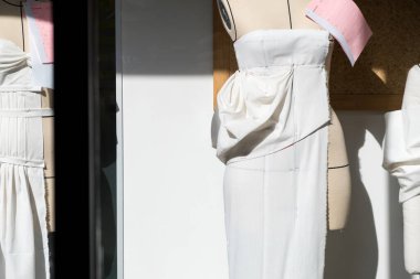 Tailor's textile female mannequin with black lines covered with canvas fabric pattern and draping for dressmakers working and designing new fashion collections in an atelier tailor workshop.