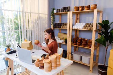 Asyalı güzel bir kadın evde canlı yayında vazo satıyor. Genç ve çekici bir kız müşteriye malını ve detaylarını gösteren akıllı telefon kullanır. Uzak satın alma ve satın alma kavramı.