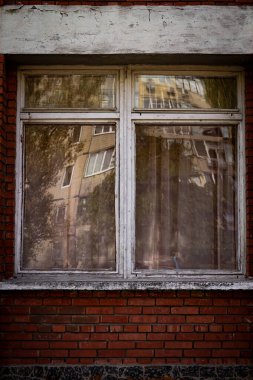 Renkli dikey fotoğraf, pencereli tuğla kırmızı bina ve ahşap çerçeveler yakın, kentsel arkaplan.