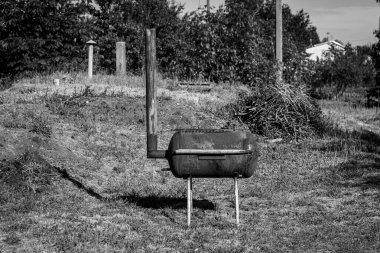 Isıtma suyu için ısıtıcıdan kendi kendine yapılmış barbekü. Ev yapımı metalden yapılmış siyah ve beyaz fotoğraf.