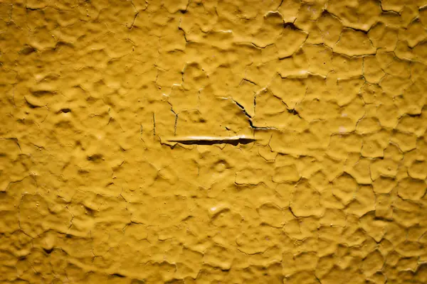 stock image Color horizontal photo, yellow faded, peeling paint on uneven surface. Texture, background image.