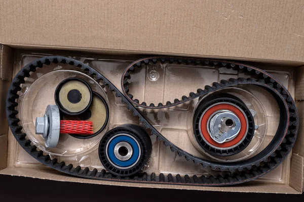 Repair kit for replacing the timing belt in a open cardboard box.