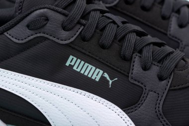 Obrenovac, Serbia - July 19, 2025: A close-up of the pastel green Puma logo on black sneakers.