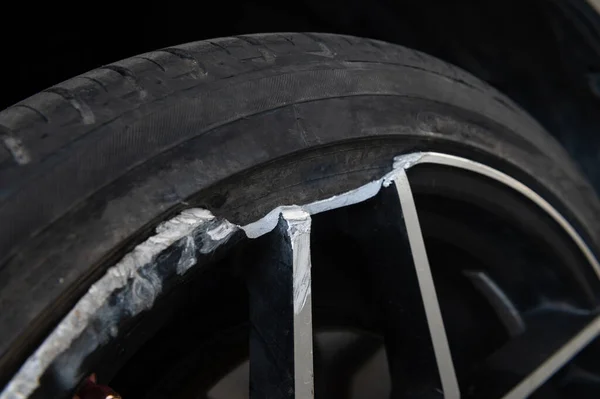 Closeup of alloy wheel with broken rim