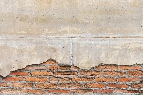 Texture of an old brick wall with fallen plaster