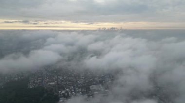 4K Hava aracı beyaz kabarık bulutların içinde geriye doğru uçuyor.