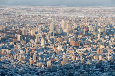 Aerial view of cityscape Sapporo downtown in winter clipart