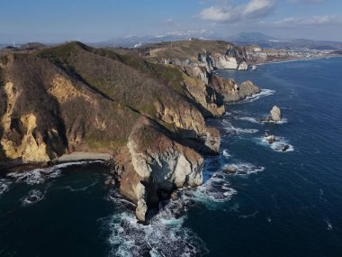 Aerial view of Cape Chikyu with rough sea breaking on cliff clipart