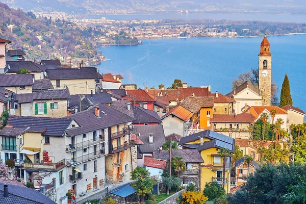 stock image The old housing of Ronco sopra Ascona with tall clocktower of San Martino Church and Lake Maggiore with Ascona bank in background, Switzerland