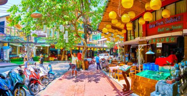 BANGKOK, THAILAND - 23 Nisan 2019: The Rambuttri Alley with tour restaurant, little shop and banyan tree with hang airial roots, on Bangkok