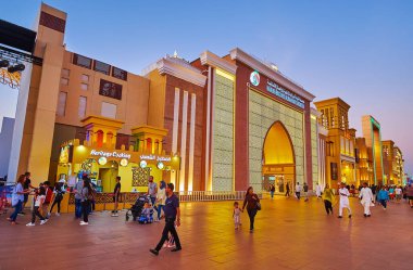 DUBAI, UAE - MARCH 6, 2020: The alley in front of the gate of UAE Pavilion in Global Village Dubai, decorated with bright evening lights, on March 6 in Dubai clipart