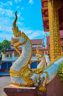 The statues of Makara crocodile, disgorging Naga serpent at the entrance to the Ubosot of Wat Saen Muang Ma, Chiang Mai, Thailand