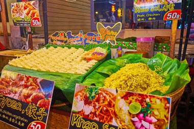 CHIANG MAI, THAILAND - MAY 3, 2019: The street food stall on Night Market with fresh dumplings and hot noodles, on May 3 in Chiang Mai
