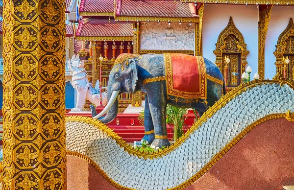 The elephant and Singha lion statue behind the Naga serpent, Wat Saen Muang Ma, Chiang Mai, Thailand
