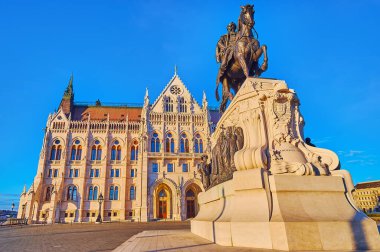 Gyula Andrassy equestrian statue on Lajos Kossuth Square and Gothic Parliament building in the evening light, Budapest, Hungary