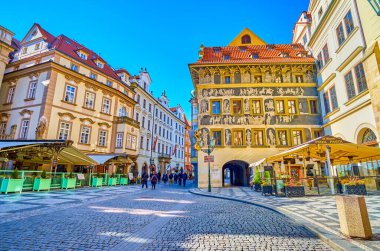 PRAGUE, CZECHIA - MARCH 11, 2022: Old Town Square (Staromestske namesti) and outstanding medieval Dum U Minuty house with frescoes, on March 11 in Prague, Czechia