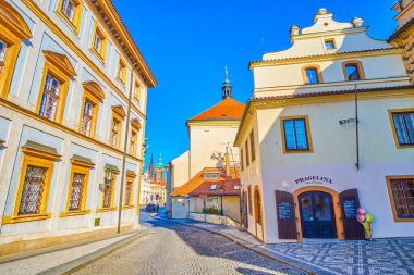PRAGUE, CZECHIA - MARCH 11, 2022: Stroll in Hradcany upper district along cozy Loretanska street passing scenic medieval buildings, on March 11 in Prague, Czechia