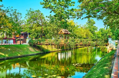 Walk along the medieval moat with niice small footbridges, decorated with wooden gate and hanging plants, Chiang Mai, Thailand