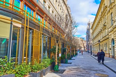 Walk down renewed pedestrian Duna Street with historic houses and green plants in pots, Budapest, Hungary