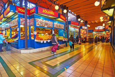 BUDAPEST, HUNGARY - FEB 22, 2022: Interior of Central Market Hall with fruits and vegetable stalls, on Feb 22 in Budapest