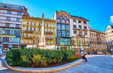 BUDAPEST, HUNGARY - FEB 22, 2022: Szervita Square with stone Immaculate Column and townhouses, including ornate Turkish Bank with mosaic decor, on Feb 22 in Budapest