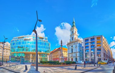 BUDAPEST, HUNGARY - FEB 22, 2022: Renovated Szervita Square with historic St Anne Church, Immaculate Column and modern glass building, Budapest, Hungary