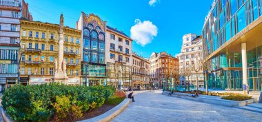 BUDAPEST, HUNGARY - FEB 22, 2022: Panorama of Szervita Square with stone Immaculate Column and line of historic and modern buildings, on Feb 22 in Budapest
