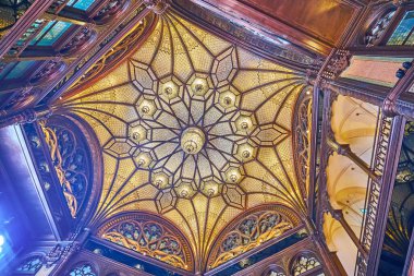 BUDAPEST, HUNGARY - FEB 22, 2022: Ornate inner dome of Paris Court (Brudern House) with carved wood and glass mosaic, on Feb 22 in Budapest