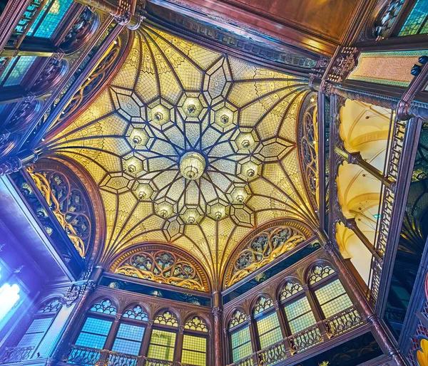 BUDAPEST, HUNGARY - FEB 22, 2022: Elegant glass dome of Paris Court (Brudern House) with carved wooden patterns, on Feb 22 in Budapest