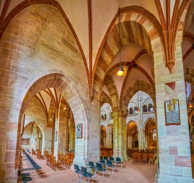 BASEL, SWITZERLAND - APRIL 1, 2022: Panorama of the prayer hall of Basel Minster Cathedral with stone arcades, on April 1 in Basel, Switzerland