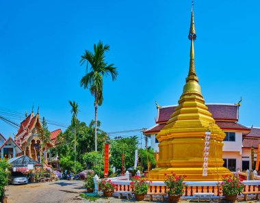 Panorama of the green garden of Wat Dap Phai with beautiful golden chedi, topped with hti umbrella, Chiang Mai, Thailand