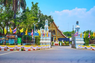 CHIANG MAI, THAILAND - MAY 3, 2019: Wat Phra Singh temple with Viharn Luang hall and white Singha lion statues at the entrance gate, on May 3 in Chiang Mai