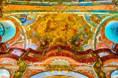 PRAGUE, CZECHIA - MARCH 11, 2022: Richly decorated walls and vault of Church of the Nativity in Loreta complex with colorful frescoes and gilden ornament, on March 11 in Prague, Czechia