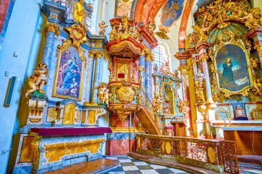 PRAGUE, CZECHIA - MARCH 11, 2022: Interior of Church of the Nativity in Loreta with Altar and golden pulpit, on March 11 in Prague, Czechia