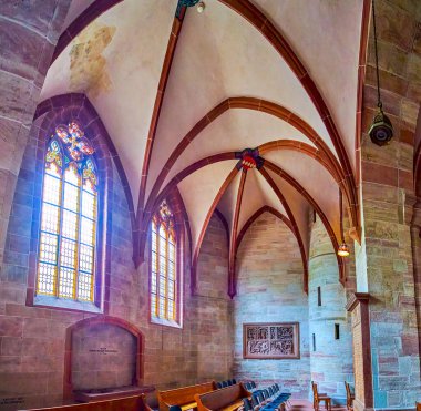 BASEL, SWITZERLAND - APRIL 1, 2022: The side Aisle of Basel Minster Cathedral with large windows and rib-vaulted ceiling, on April 1 in Basel, Switzerland