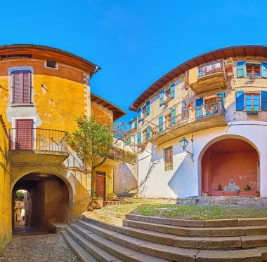 Panoramic view of the medieval shabby housing of Piazza Paolo Pagani square, Castello, Valsolda, Italy