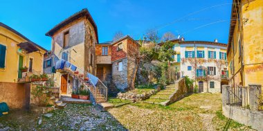 Panorama of the medieval Piazza Rusciett with historic houses and pedestrian area, Castello, Valsolda, Italy