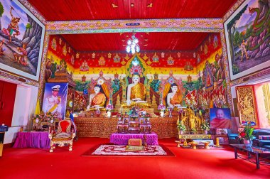 CHIANG MAI, THAILAND - MAY 3, 2019: Interior of the Viharn of Wat Chetawan with Burmese style Buddha images and colored murals, Chiang Mai, Thailand