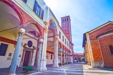 Ancient arcades and the bell tower of Basilica of Sant'Ambrogio complex in Milan, Italy