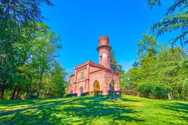 Visconti turret, the medieval building complex with the tower among the greenery of Monza Royal Gardens, Italy clipart