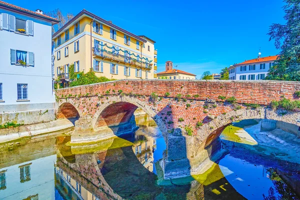 Medieval brick arched Ponte di San Gerardino bridge above Lambro river in Monza town, Italy